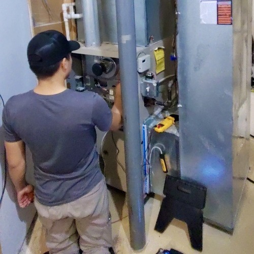 HVAC contractor checks a furnace.